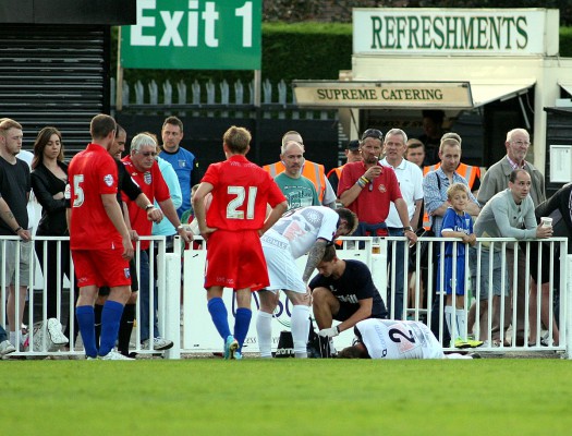 3E3B8767 - Sam Long receives treatment before being stretchered off